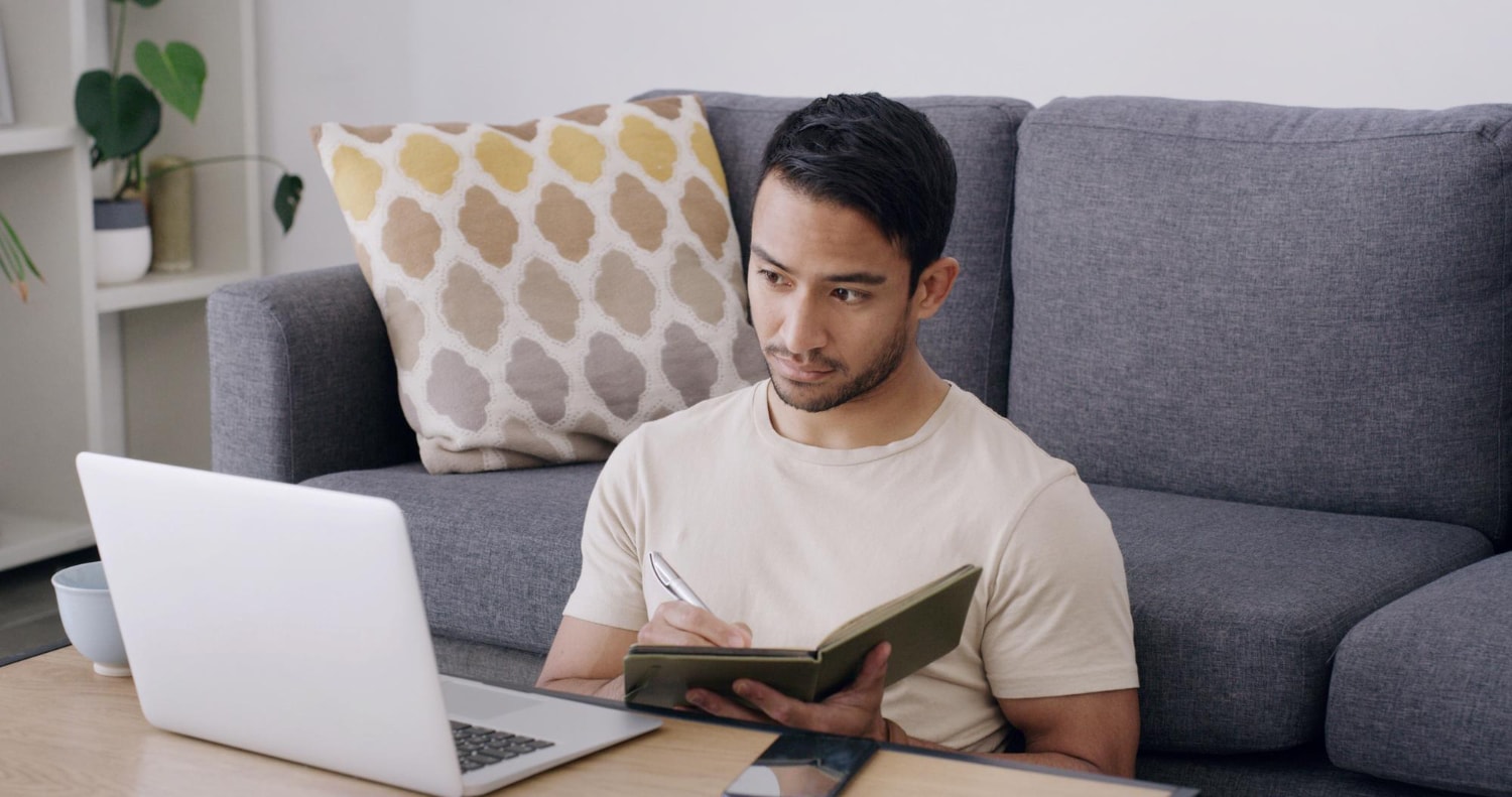 Student lernt entspannt zu Hause und macht sich Notizen